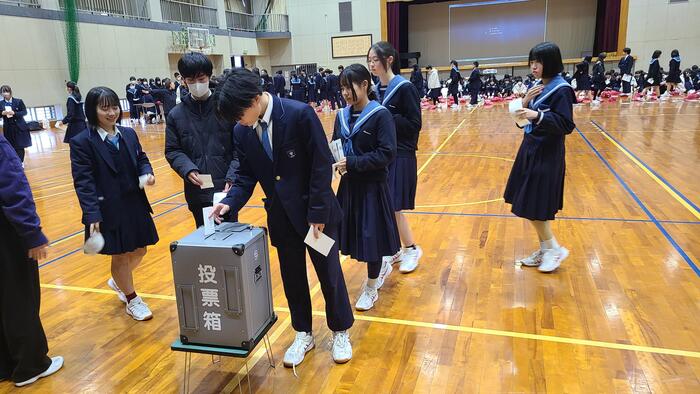 1月21日(火)7限に2年生が政治的教養を育む教育の一環で体育館で「模擬投票」を行いました。